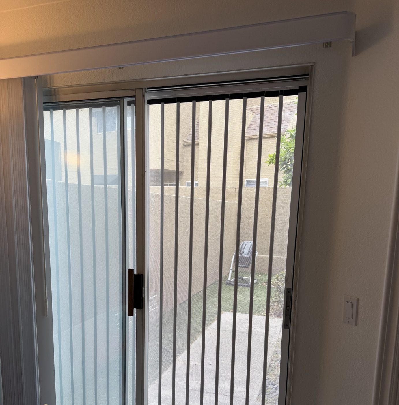 White folding screen on a sliding patio door, seen from inside